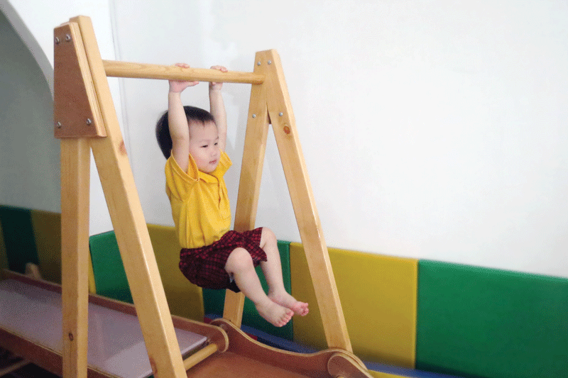 Joann hanging on a bar.